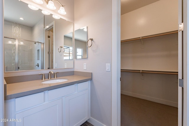 bathroom featuring walk in shower and vanity