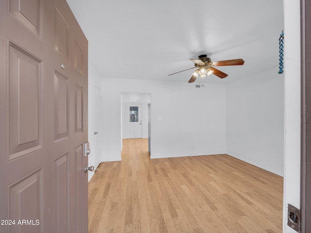 empty room featuring ceiling fan and light hardwood / wood-style floors