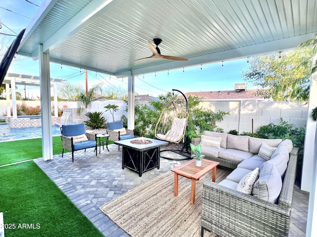 view of patio with an outdoor living space with a fire pit