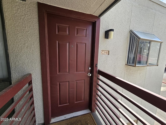 view of exterior entry featuring stucco siding