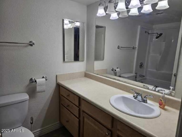 bathroom featuring toilet, vanity, and shower / bath combination