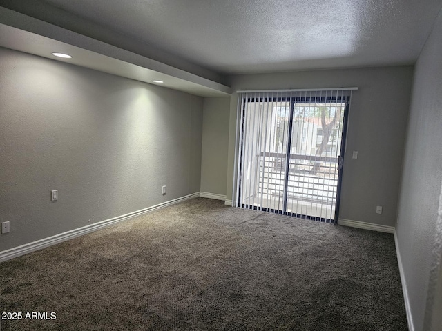 empty room featuring baseboards and carpet