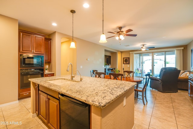 20742 E Mockingbird Dr, Queen Creek, AZ 85142 - kitchen featuring a sink, a center island with sink, black appliances, brown cabinetry, and open floor plan