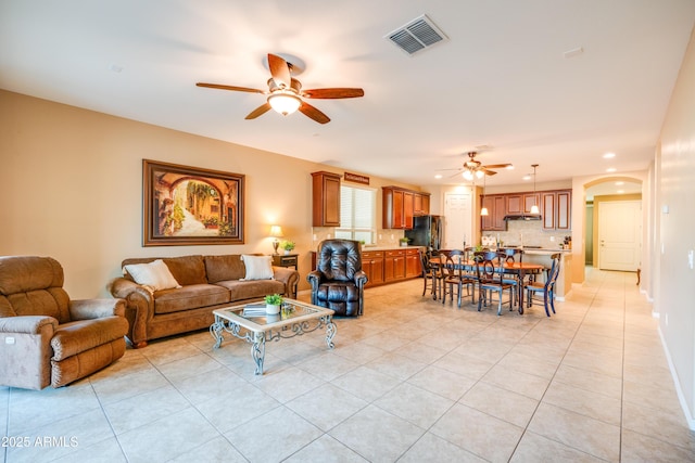 20742 E Mockingbird Dr, Queen Creek, AZ 85142 - living area featuring recessed lighting, visible vents, light tile patterned floors, arched walkways, and ceiling fan