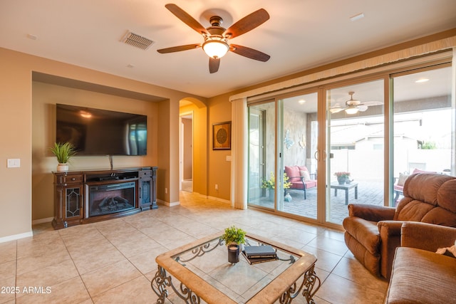 20742 E Mockingbird Dr, Queen Creek, AZ 85142 - living area with arched walkways, light tile patterned flooring, baseboards, visible vents, and a ceiling fan