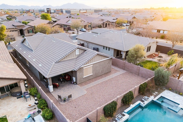 aerial view at dusk featuring a mountain view