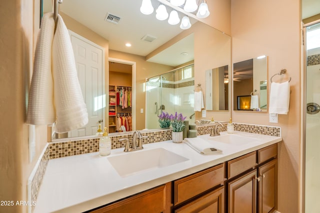 20742 E Mockingbird Dr, Queen Creek, AZ 85142 - bathroom with double vanity, a sink, visible vents, and a stall shower