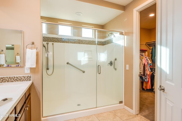 20742 E Mockingbird Dr, Queen Creek, AZ 85142 - bathroom featuring tile patterned floors, vanity, a walk in closet, and a stall shower