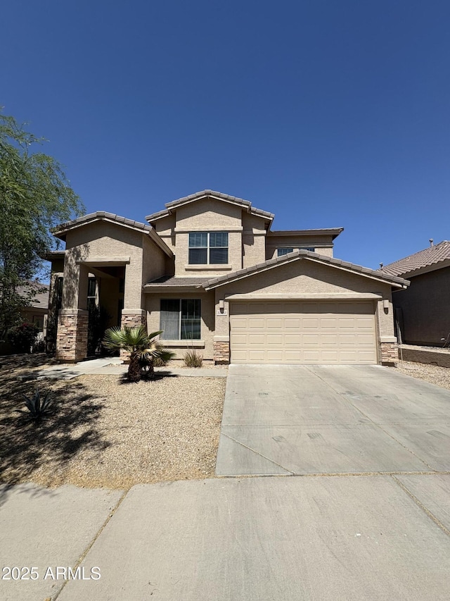 33512 N 24th Ln, Phoenix, AZ 85085 - view of front of house with stucco siding, concrete driveway, a garage, and stone siding