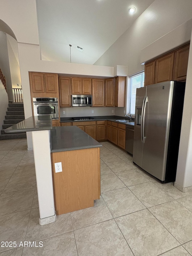33512 N 24th Ln, Phoenix, AZ 85085 - kitchen featuring appliances with stainless steel finishes, dark countertops, a sink, high vaulted ceiling, and brown cabinets