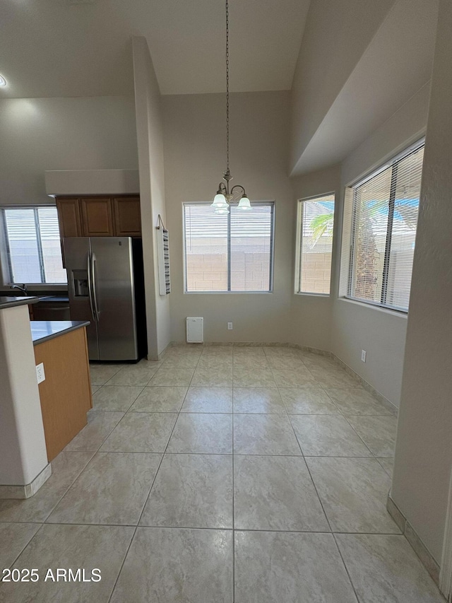 33512 N 24th Ln, Phoenix, AZ 85085 - unfurnished dining area with a chandelier, healthy amount of natural light, and light tile patterned flooring