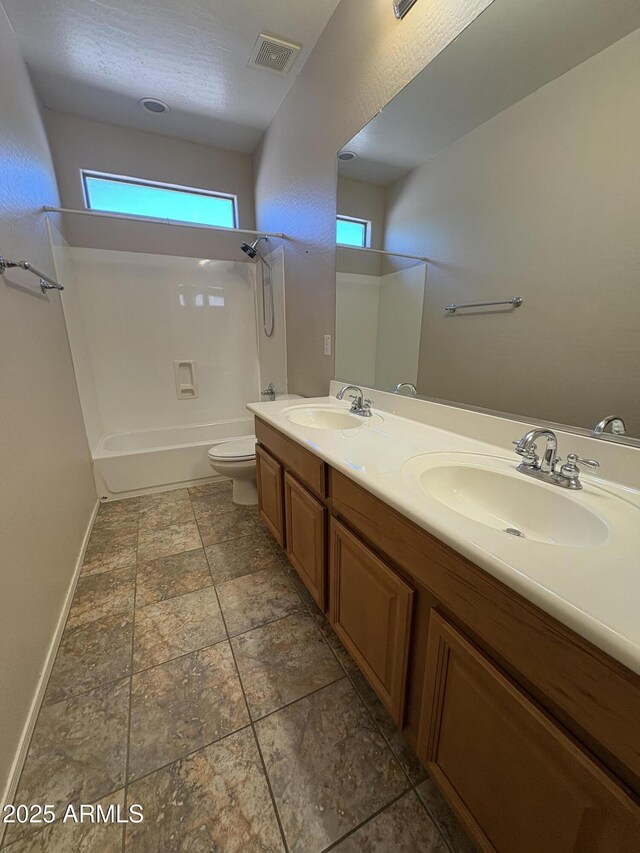 33512 N 24th Ln, Phoenix, AZ 85085 - bathroom with toilet, tub / shower combination, double vanity, baseboards, and stone finish floors