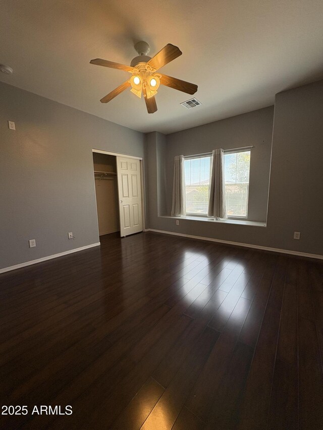 33512 N 24th Ln, Phoenix, AZ 85085 - unfurnished bedroom with a closet, dark wood finished floors, baseboards, and a ceiling fan