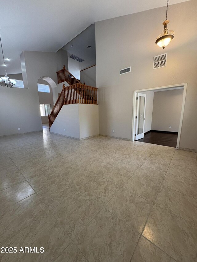 33512 N 24th Ln, Phoenix, AZ 85085 - unfurnished living room with a high ceiling, arched walkways, and stairs