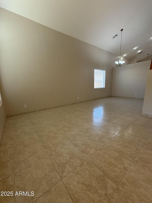 33512 N 24th Ln, Phoenix, AZ 85085 - empty room featuring lofted ceiling, light tile patterned floors, and a chandelier