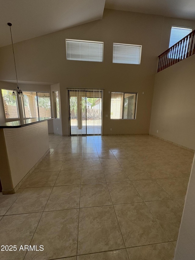 33512 N 24th Ln, Phoenix, AZ 85085 - empty room featuring high vaulted ceiling, light tile patterned flooring, and a chandelier