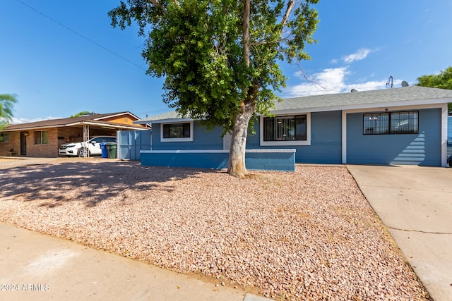 ranch-style house featuring a carport