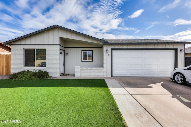 ranch-style house featuring a garage and a front lawn