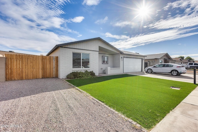 single story home with a garage and a front lawn