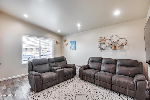 living room with hardwood / wood-style floors and lofted ceiling