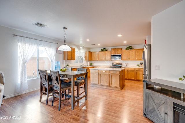 dining room with light hardwood / wood-style flooring