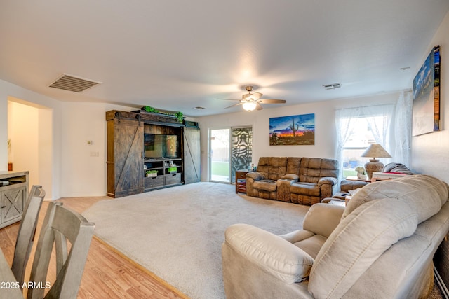 living room featuring ceiling fan and light wood-type flooring