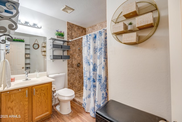 bathroom with curtained shower, hardwood / wood-style floors, toilet, and vanity