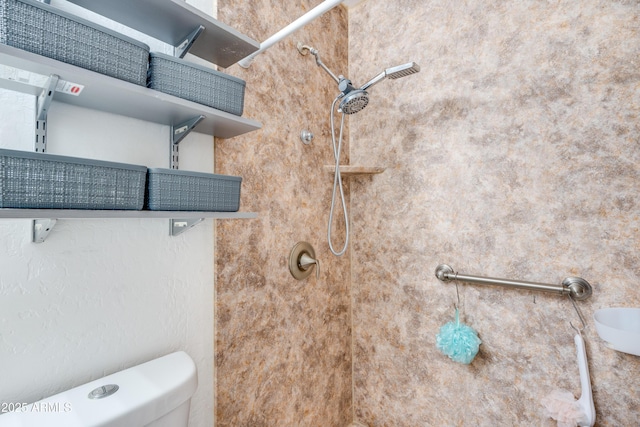 bathroom featuring toilet and tiled shower