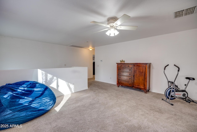 living area with ceiling fan and light carpet