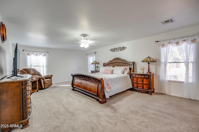 bedroom featuring light carpet and ceiling fan