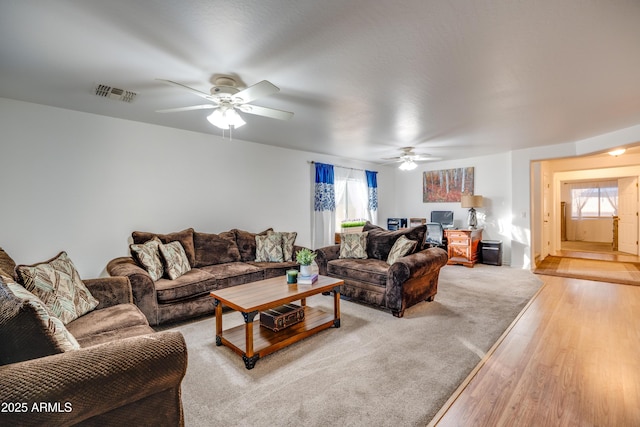 living room with light hardwood / wood-style floors and ceiling fan