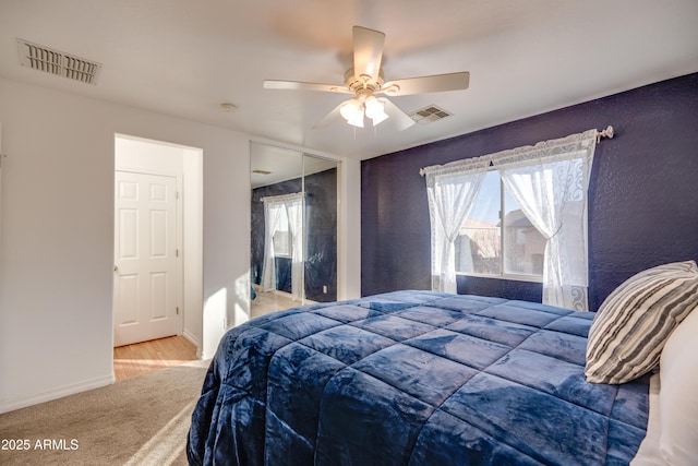 bedroom with multiple windows, carpet floors, a closet, and ceiling fan