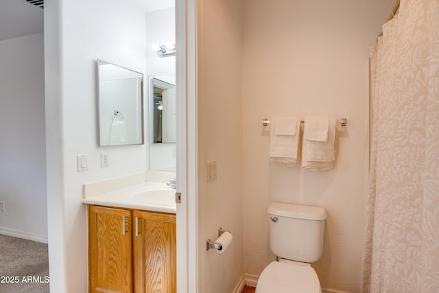 bathroom featuring toilet and vanity