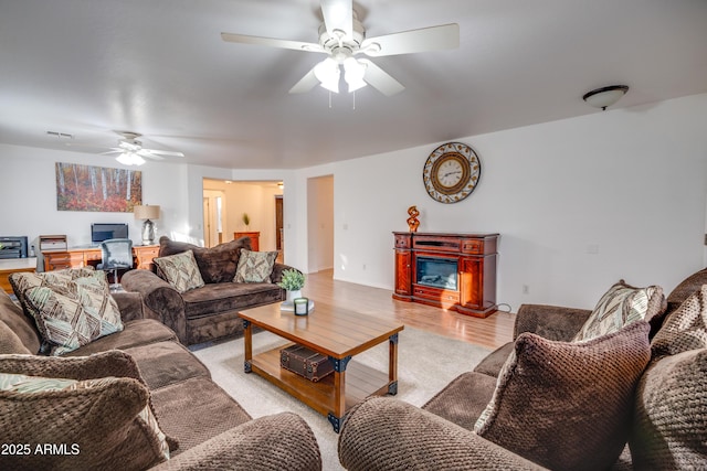 living room featuring light wood-type flooring and ceiling fan