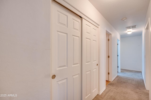 hallway with light carpet