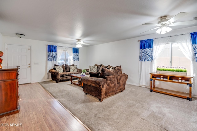 living room featuring light hardwood / wood-style floors and ceiling fan