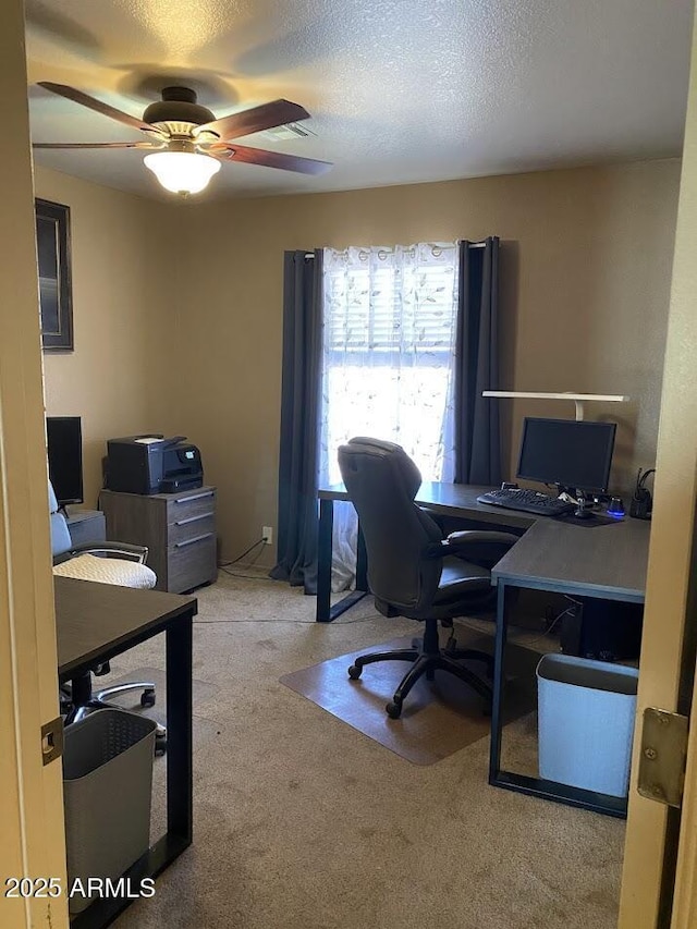 office space featuring a ceiling fan, a textured ceiling, and carpet flooring