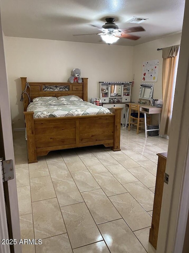 bedroom with light tile patterned flooring, visible vents, and a ceiling fan