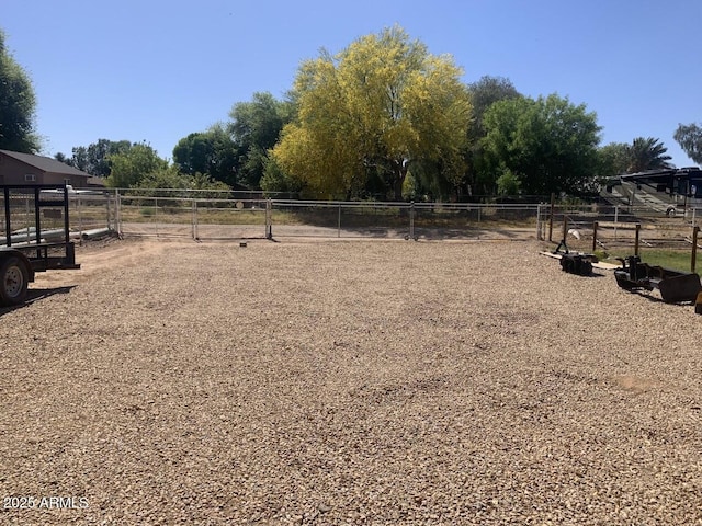 view of yard with a rural view and fence