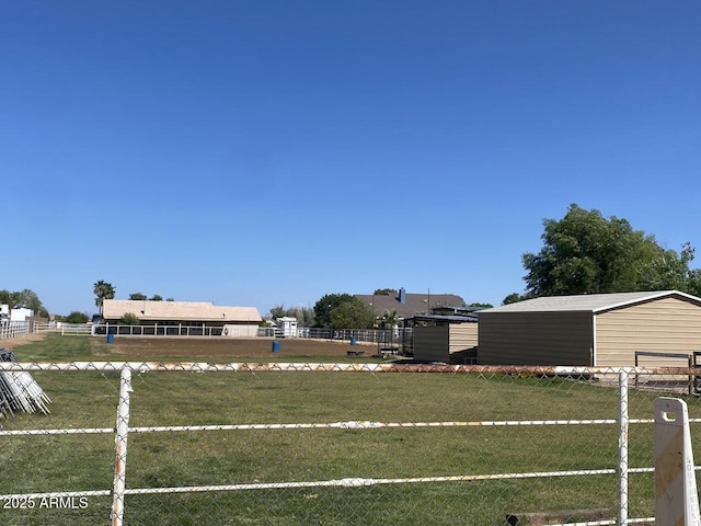 view of yard with fence and an outdoor structure