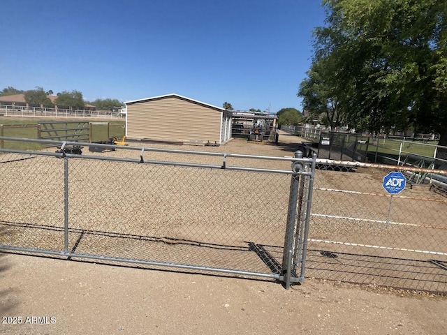 view of front facade featuring an outbuilding, fence, and a gate
