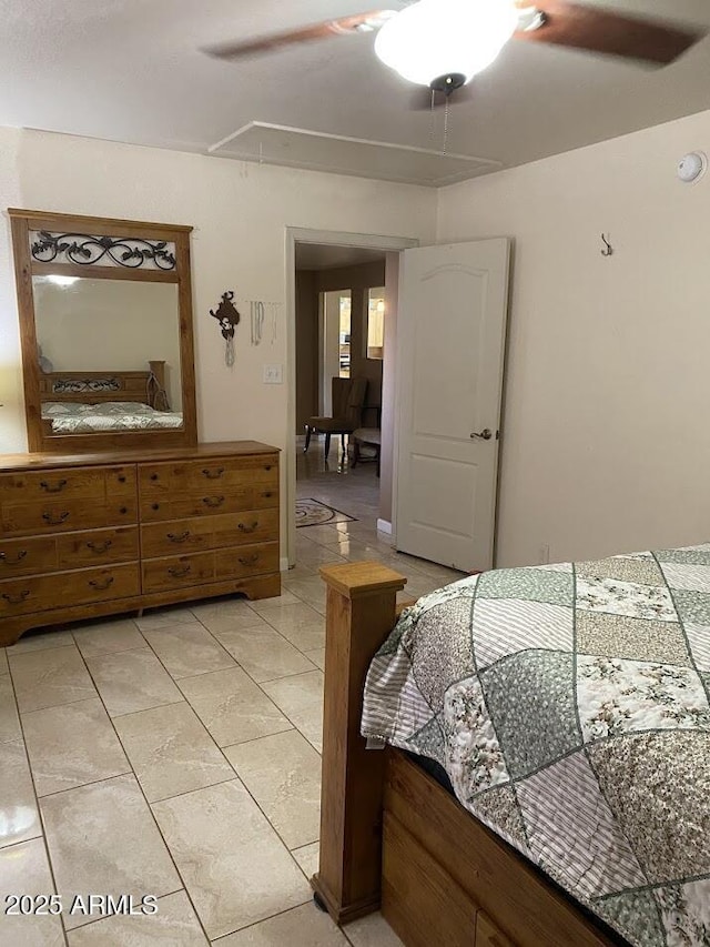 bedroom with attic access, light tile patterned flooring, and ceiling fan