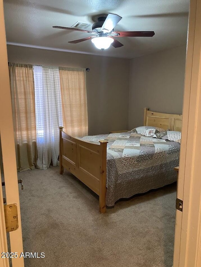 carpeted bedroom with a ceiling fan