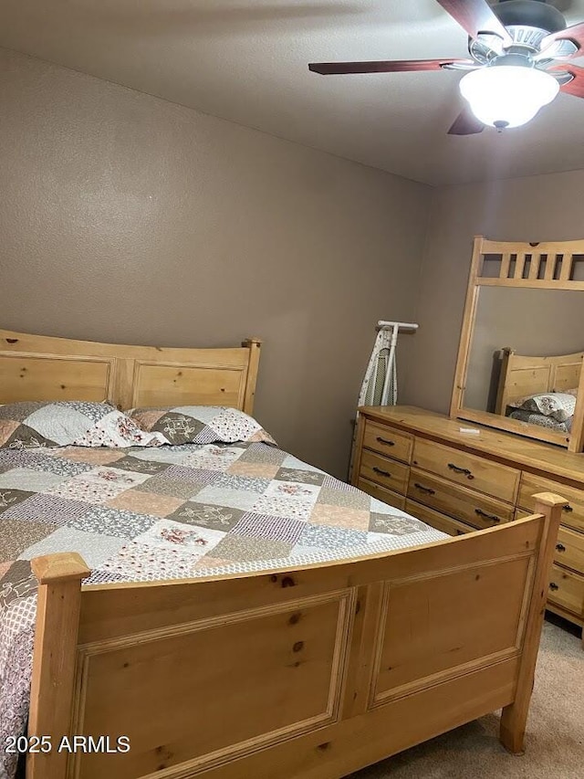 bedroom with a ceiling fan and light colored carpet