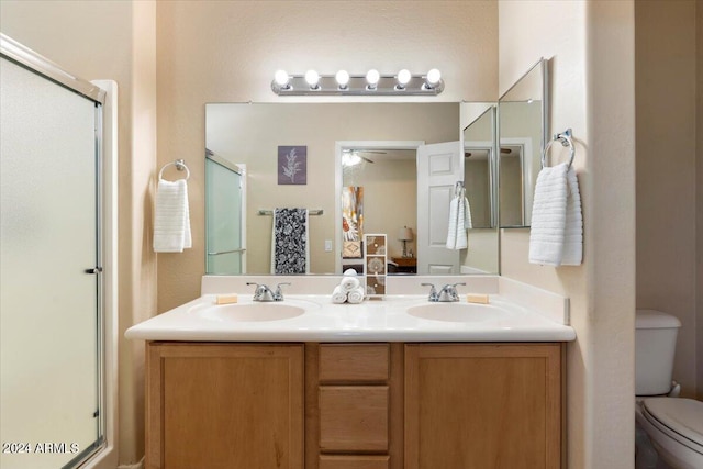 bathroom with vanity, toilet, and walk in shower