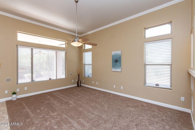 unfurnished room featuring carpet, a healthy amount of sunlight, and ornamental molding