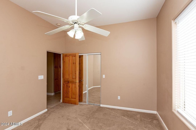 unfurnished bedroom featuring light carpet, a closet, and ceiling fan