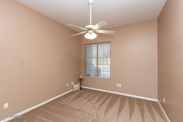 carpeted spare room featuring ceiling fan