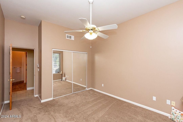 unfurnished bedroom with a closet, ceiling fan, and carpet