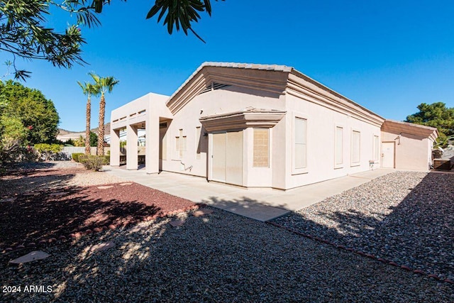 back of house with a patio